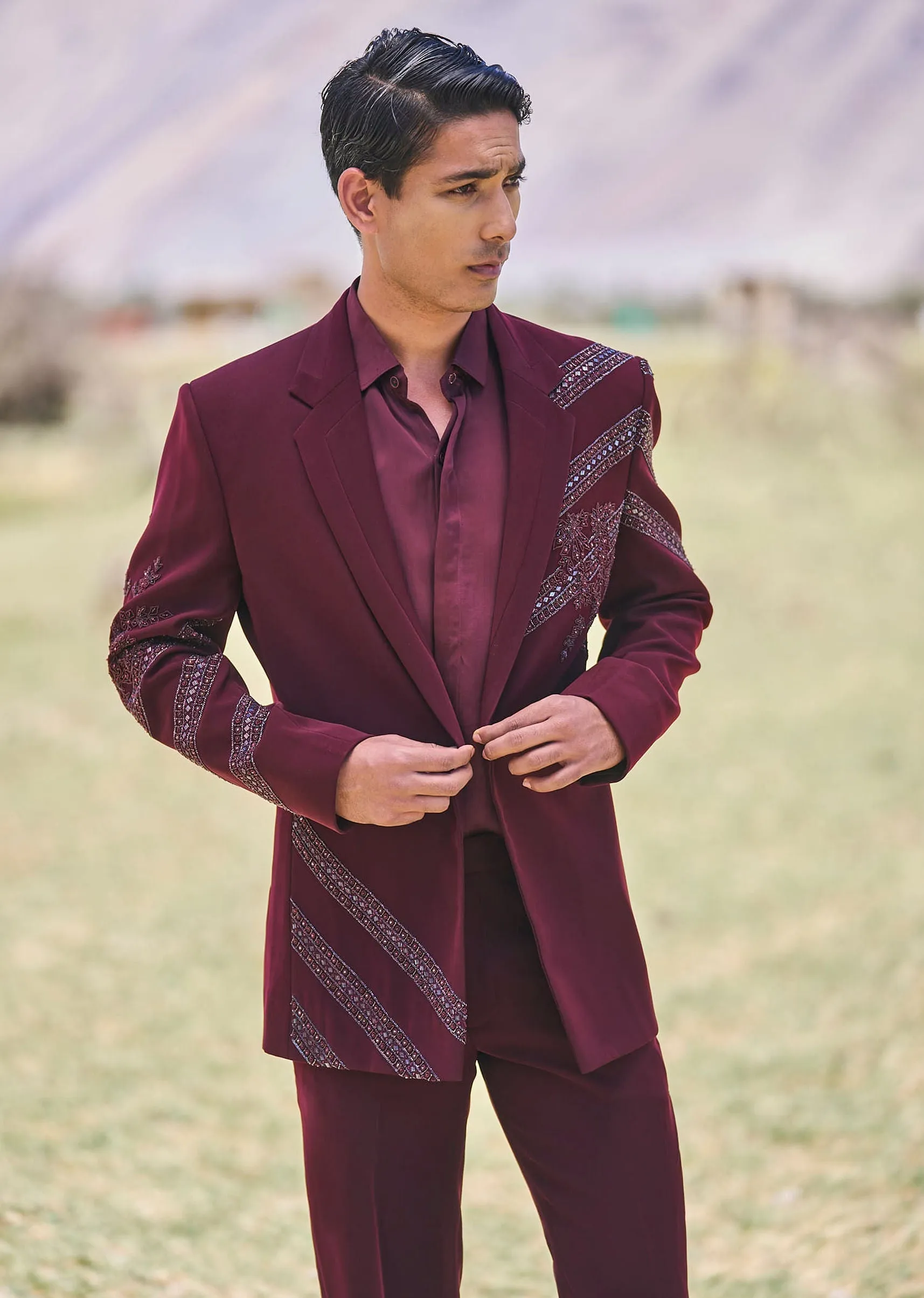 Deep Wine Self Embroidered Tuxedo With Geometric Motifs