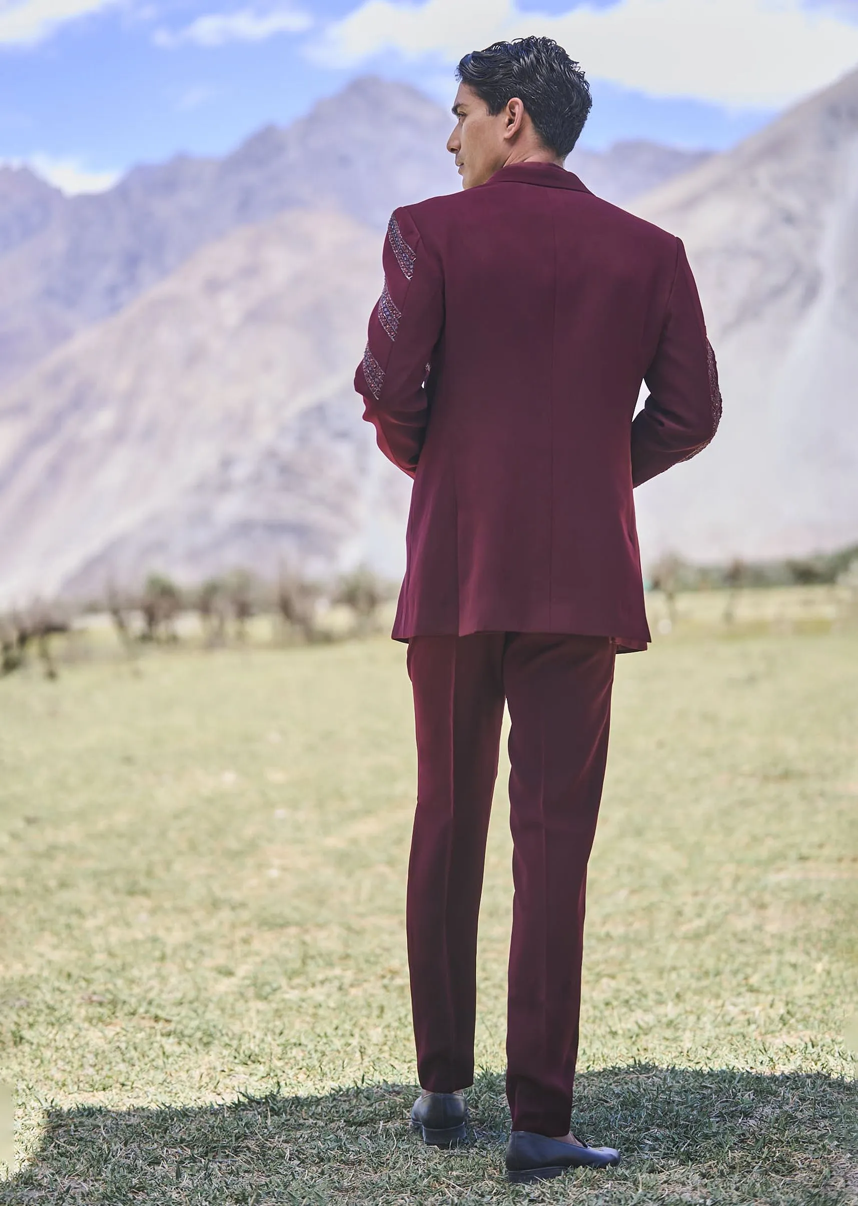 Deep Wine Self Embroidered Tuxedo With Geometric Motifs